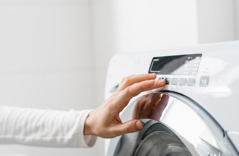 female-hand-press-button-washing-machine-indoors_754108-3249