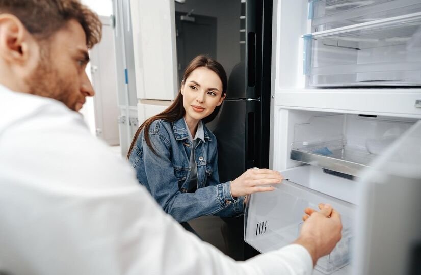 young-couple-selecting-new-refrigerator-household-appliance-store_93675-139752